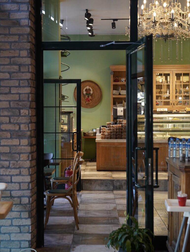 Modern and cozy interior design of Ceviz Ev Yapımı bakery featuring brick walls and an illuminated display case.