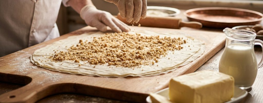 The moment walnuts are sprinkled over pastry dough from the master's hand, butter and milk.