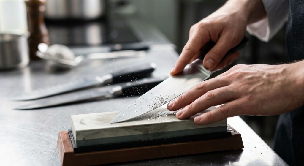Sharpening a chef knife with a whetstone for kitchen safety